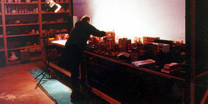Color photo showing E.J. Gold dressing miniature set for a shoot
